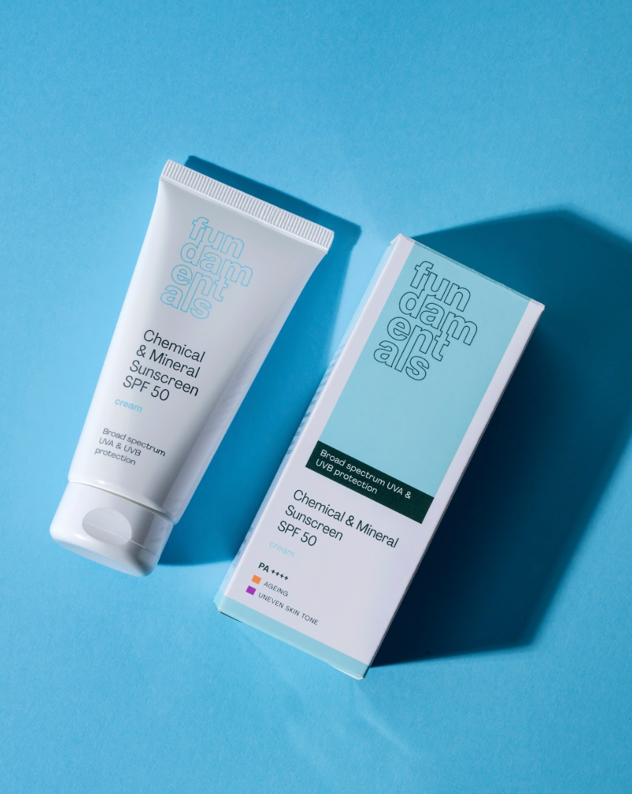Tube and box of Fundamental Chemical & Mineral Sunscreen SPF 50 on a blue background