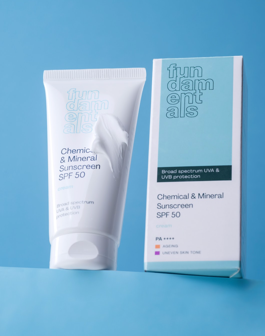 Sunscreen tube and packaging on a blue background