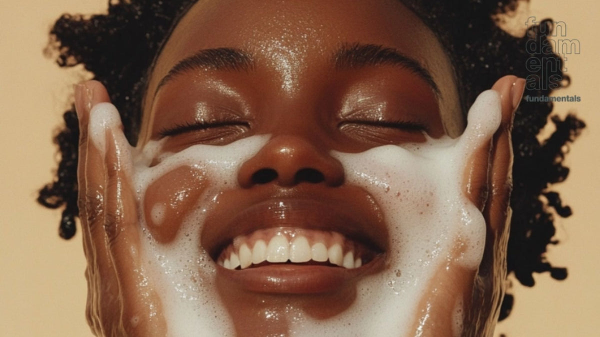 Person washing their face with a beige background
