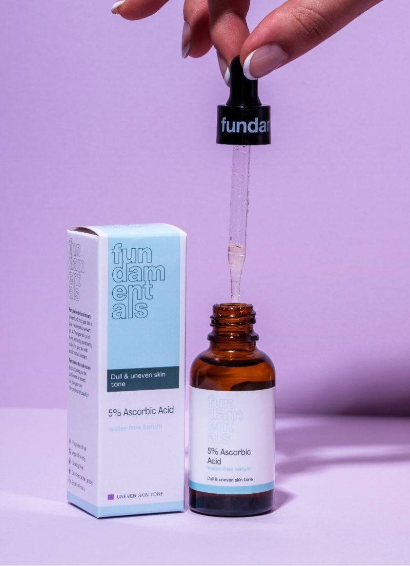 Fundamentals Skincare serum being lifted from its carton